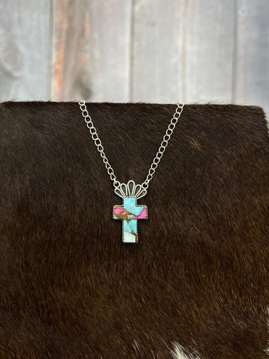 Necklace with a cross pendant on a brown  fur surface