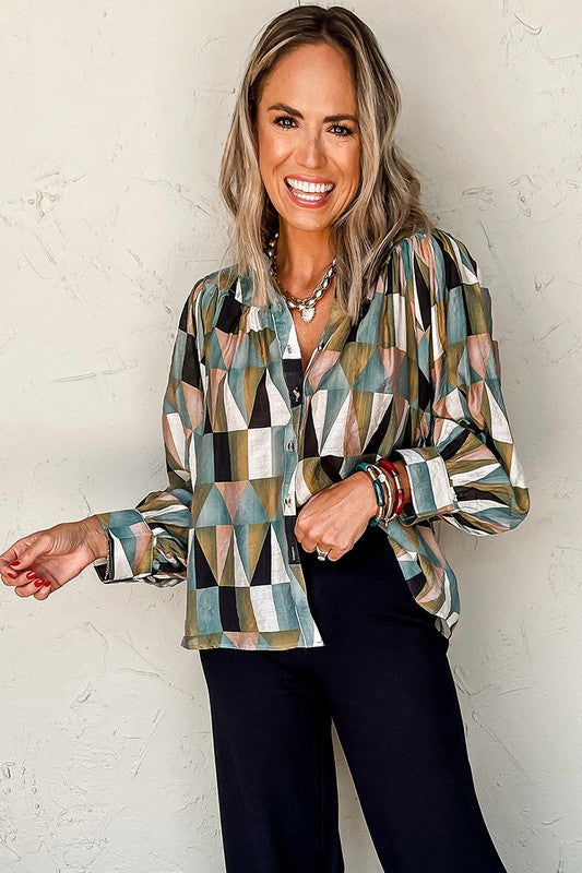 Woman wearing a patterned shirt against a white brick wall